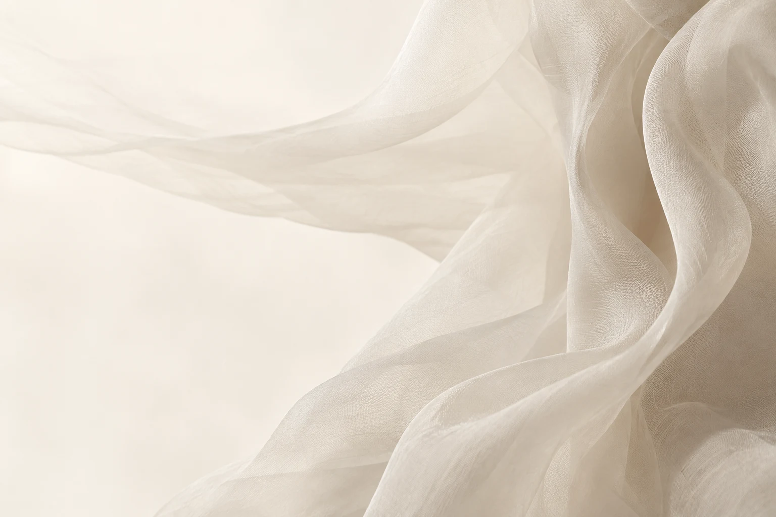 Weightless ivory fabric moving softly in the light